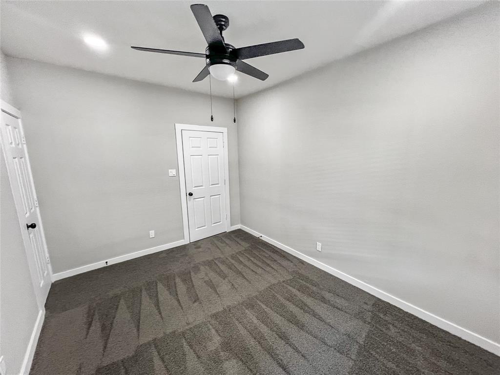 5530 Reiger Avenue, Unit 5528 Dallas, TX 75214 - Photo 28 of 40 an empty room with a ceiling fan and wooden floor
