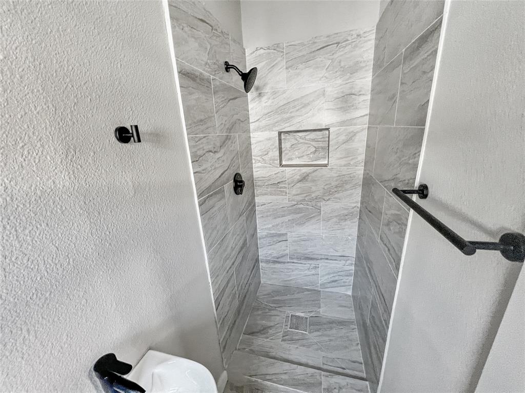 5530 Reiger Avenue, Unit 5528 Dallas, TX 75214 - Photo 33 of 40 a bathroom with a shower and toilet