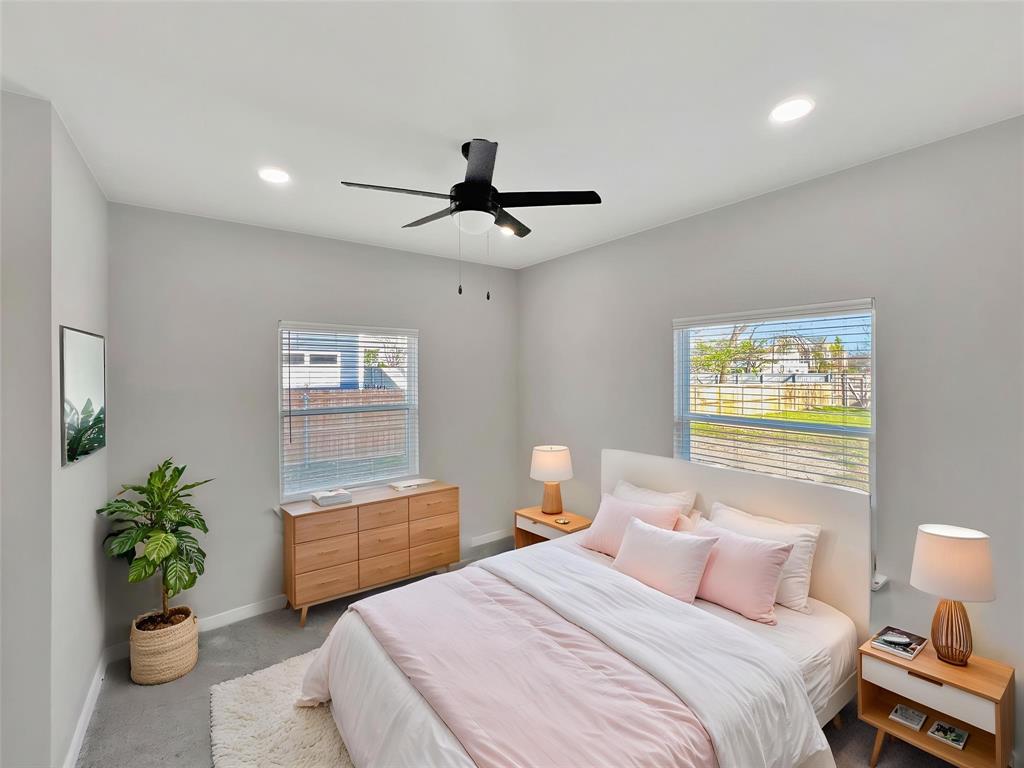 5530 Reiger Avenue, Unit 5528 Dallas, TX 75214 - Photo 4 of 40 a bedroom with a bed and a chandelier