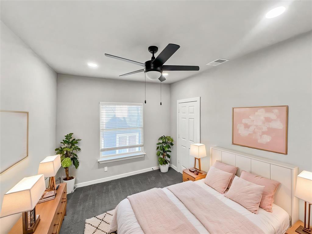 5530 Reiger Avenue, Unit 5528 Dallas, TX 75214 - Photo 6 of 40 a bedroom with a bed and a potted plant