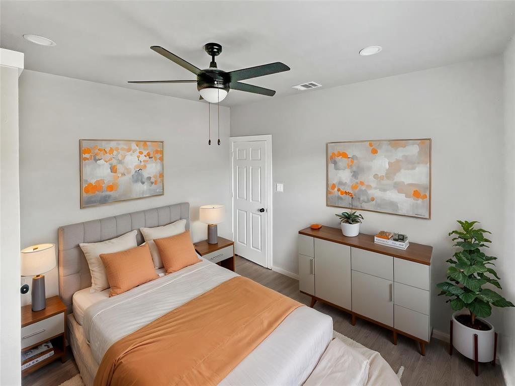 5530 Reiger Avenue, Unit 5528 Dallas, TX 75214 - Photo 7 of 40 a bedroom with bed and paintings on the wall