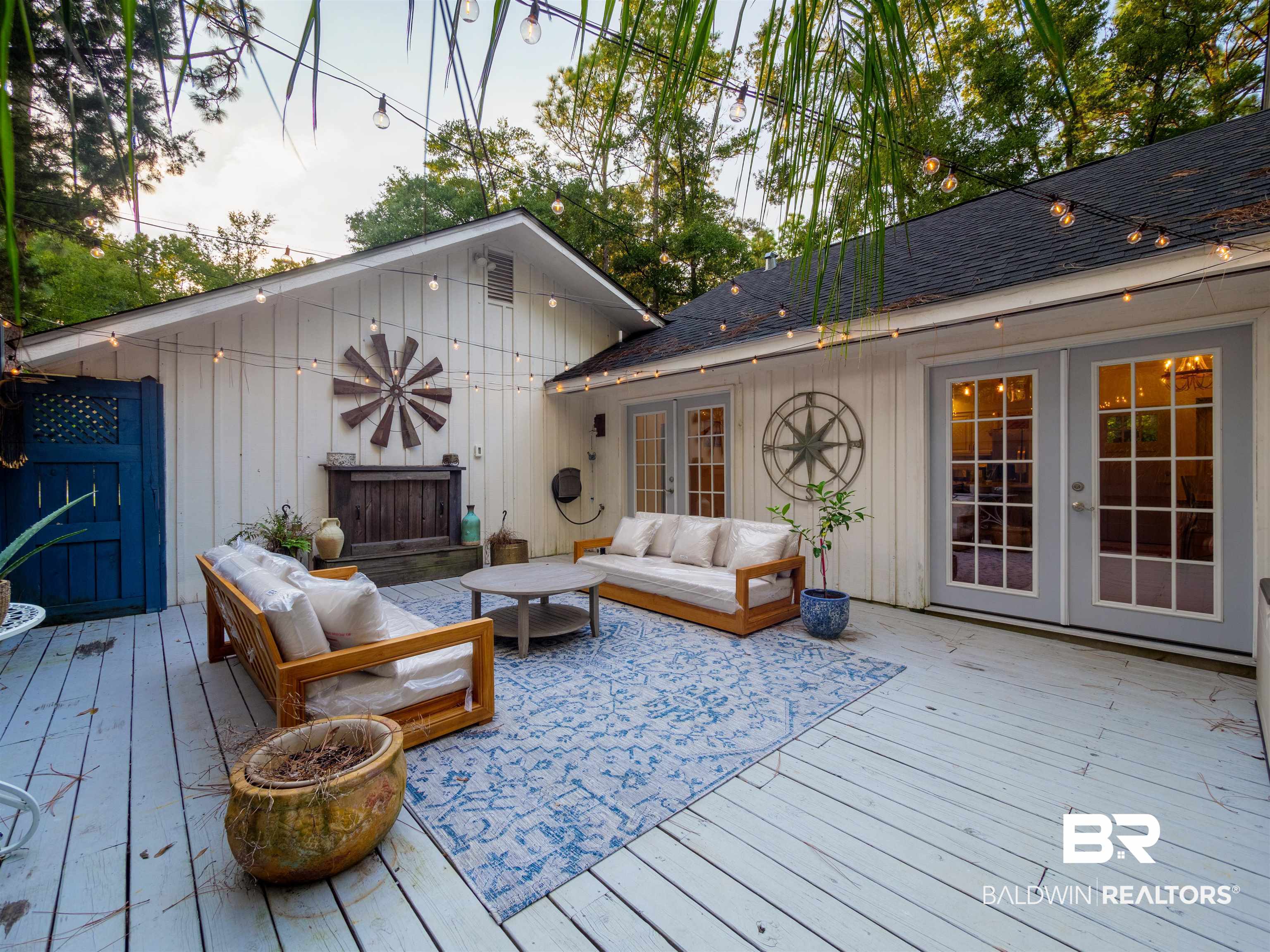 494 Ridgewood Drive Daphne, AL 36526 - Photo 31 of 40 Deck at dusk with french doors and an outdoor hangout area