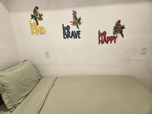 a bedroom with a bed and a chair