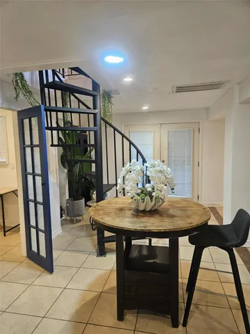 a bedroom with a bed and a wooden floor