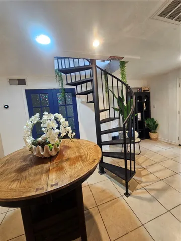a bedroom with a bed and a potted plant