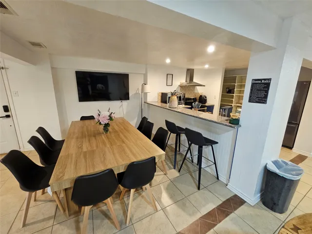 a view of livingroom with fireplace flat screen tv and staircase