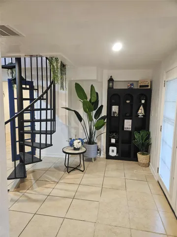 a living room with furniture a dining table and chairs with wooden floor