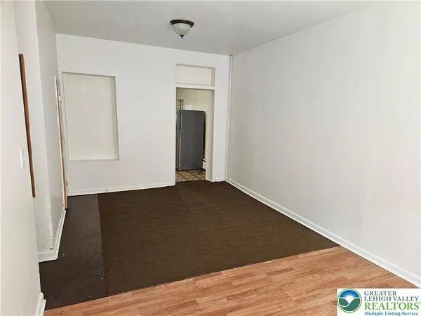 an empty room with wooden floor