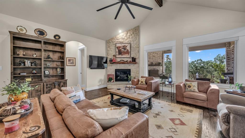 1320 Post Oak Road Gordon, TX 76453 - Photo 12 of 40 a living room with furniture a fireplace and a chandelier