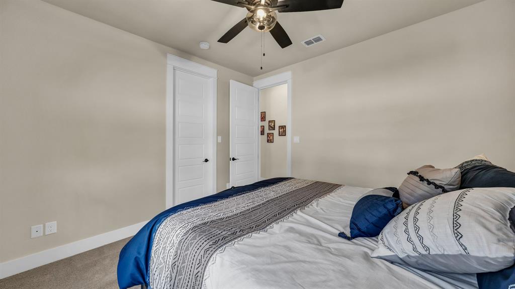 1320 Post Oak Road Gordon, TX 76453 - Photo 26 of 40 a bedroom with a bed and a chandelier
