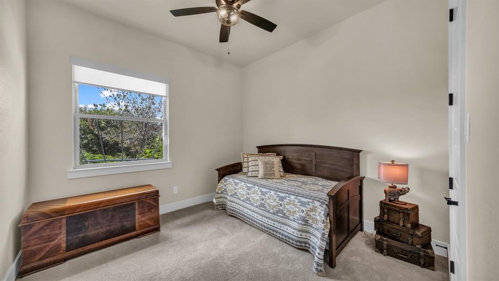 1320 Post Oak Road Gordon, TX 76453 - Photo 28 of 40 a bedroom with a bed and a ceiling fan