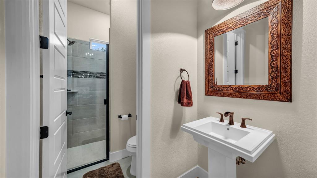 1320 Post Oak Road Gordon, TX 76453 - Photo 30 of 40 a bathroom with a sink and mirror with toilet
