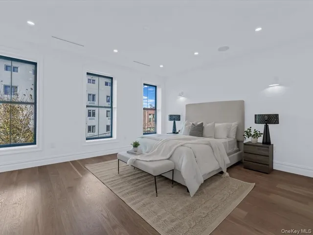 a spacious bedroom with a bed and a window