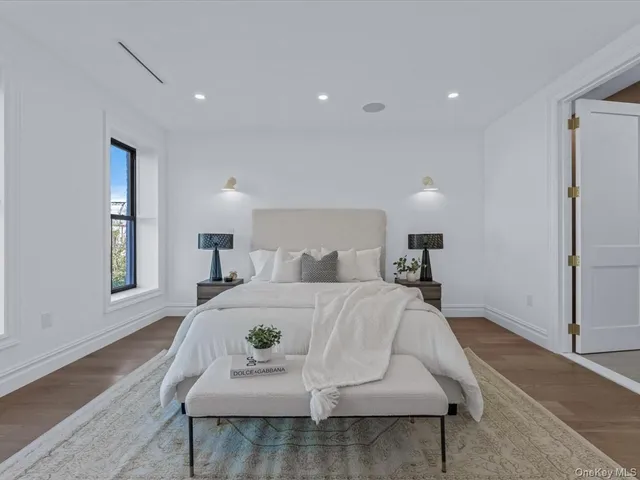 a spacious bedroom with a bed and a couch