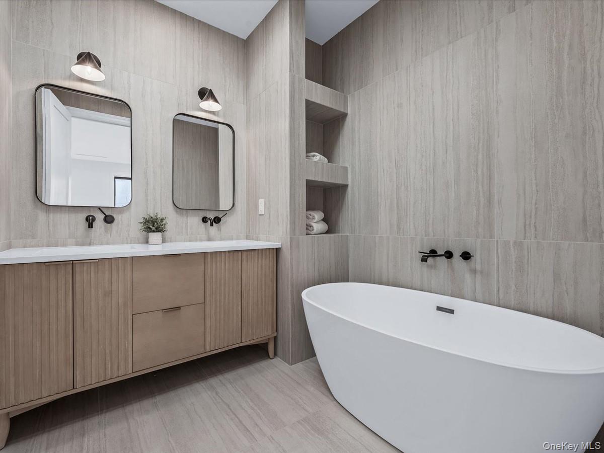 753 Hancock Street, Unit HSE Brooklyn, NY 11233 - Photo 15 of 46 a bathroom with a bathtub a double vanity sink and mirror