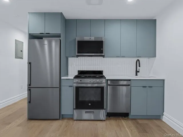 a kitchen with a refrigerator stove and microwave