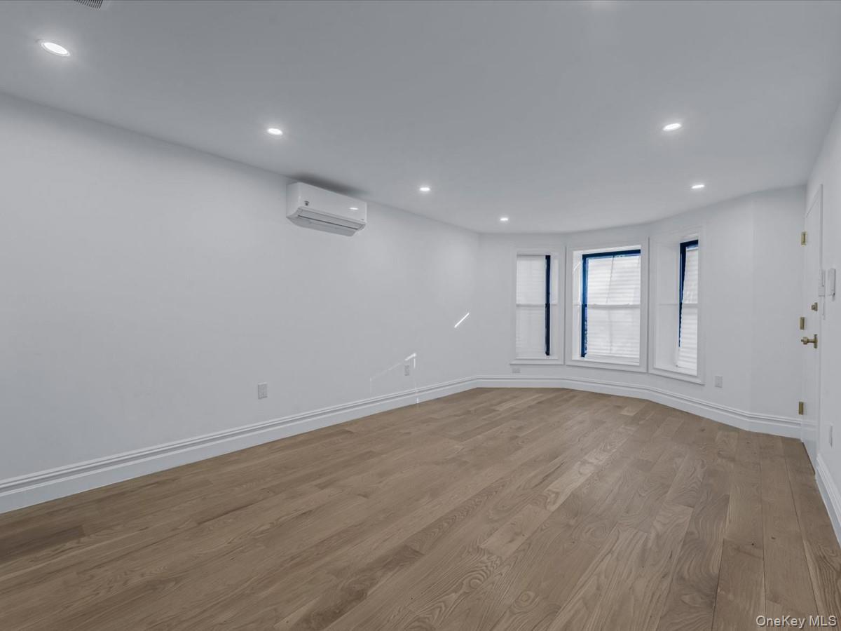 753 Hancock Street, Unit HSE Brooklyn, NY 11233 - Photo 27 of 46 a view of an empty room with wooden floor and a window