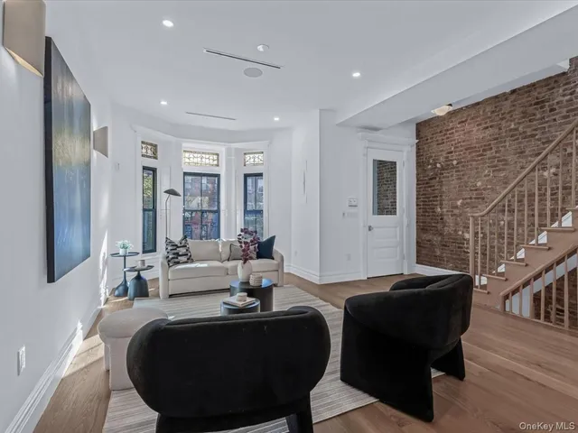 a living room with furniture and large windows