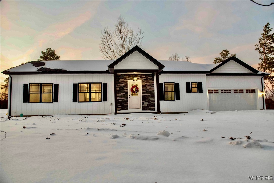 BOARD AND BATTEN SIDING WITH AN ACCENT OD STONE AT