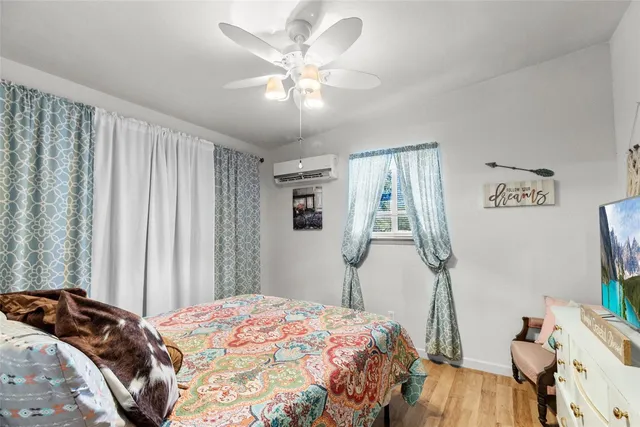 a bedroom with a large bed and a chandelier