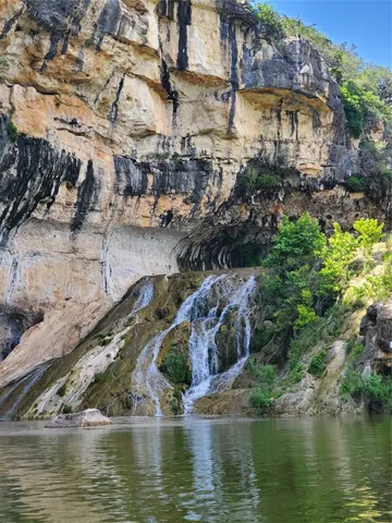 a view of a lake with houses in the background