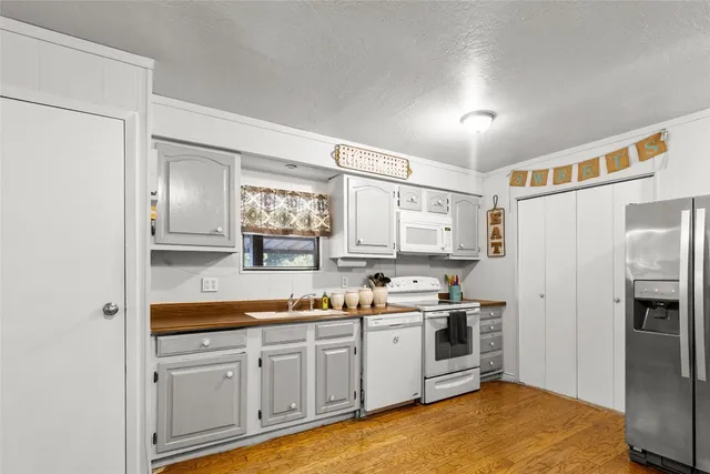 a view of a kitchen with dining table and chairs