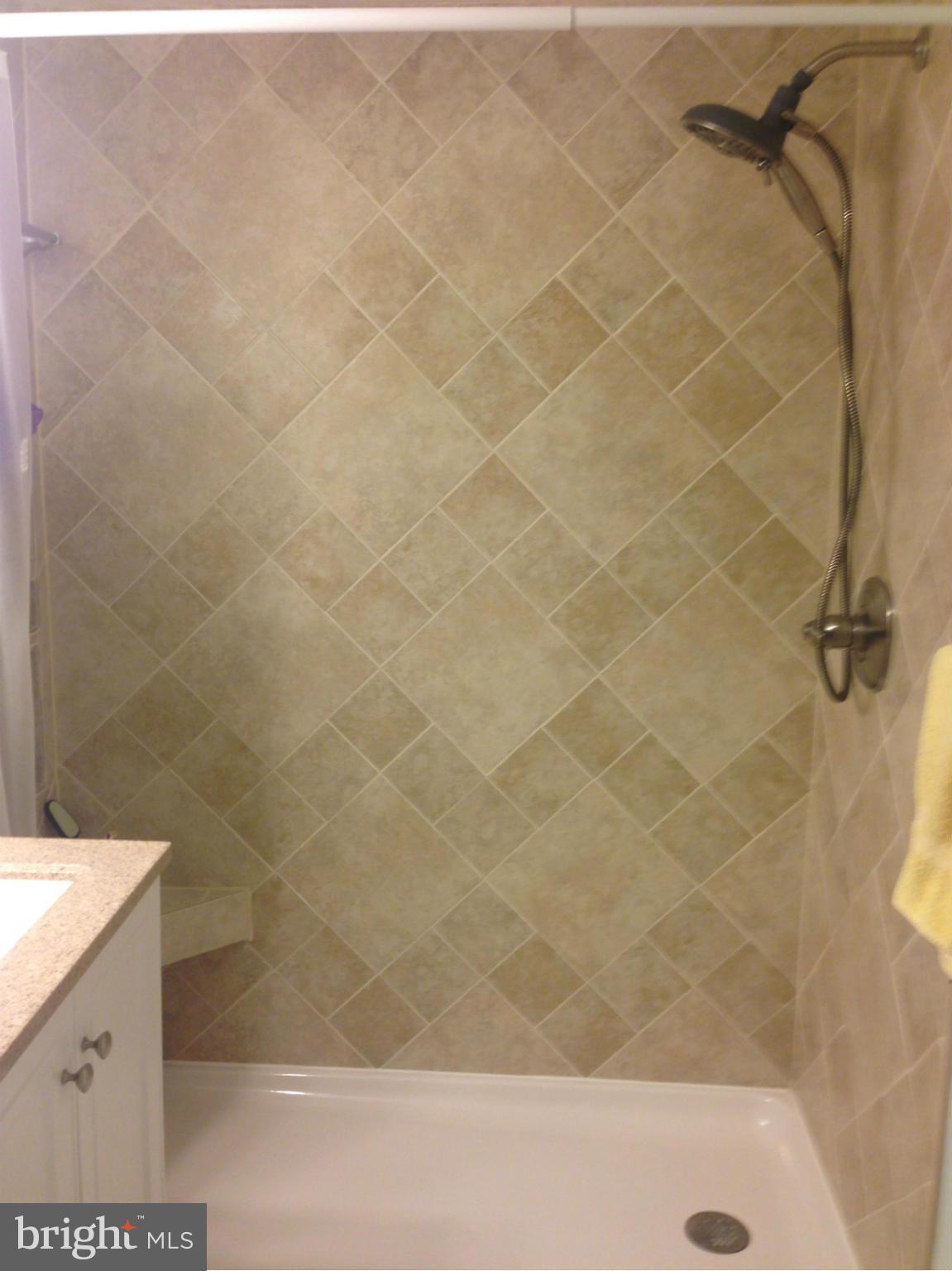 11368 Cherry Hill Road, Unit 304 Beltsville, MD 20705 - Photo 5 of 11 a bathroom with a bathtub