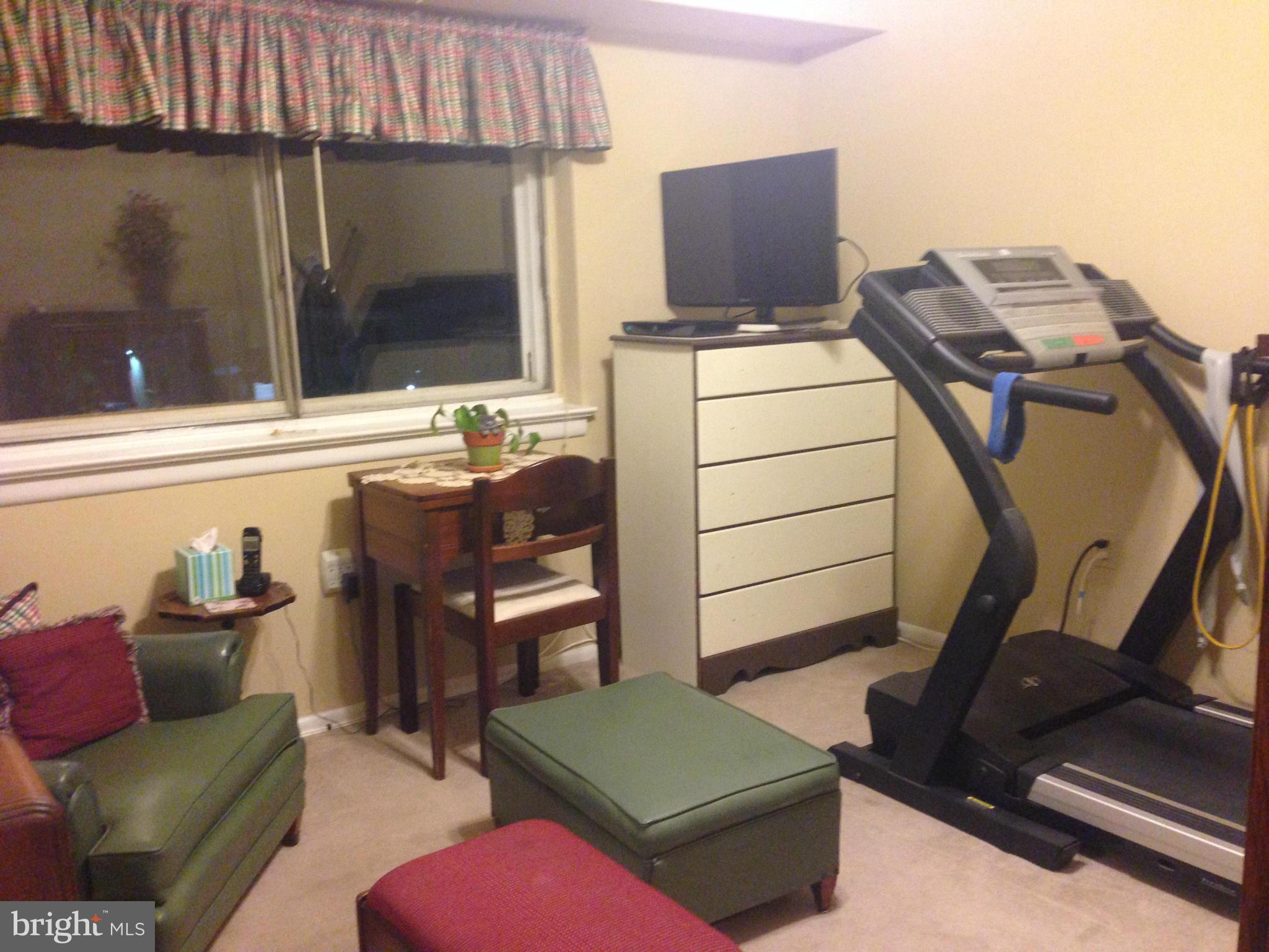 11368 Cherry Hill Road, Unit 304 Beltsville, MD 20705 - Photo 6 of 11 a room with furniture and a flat screen tv