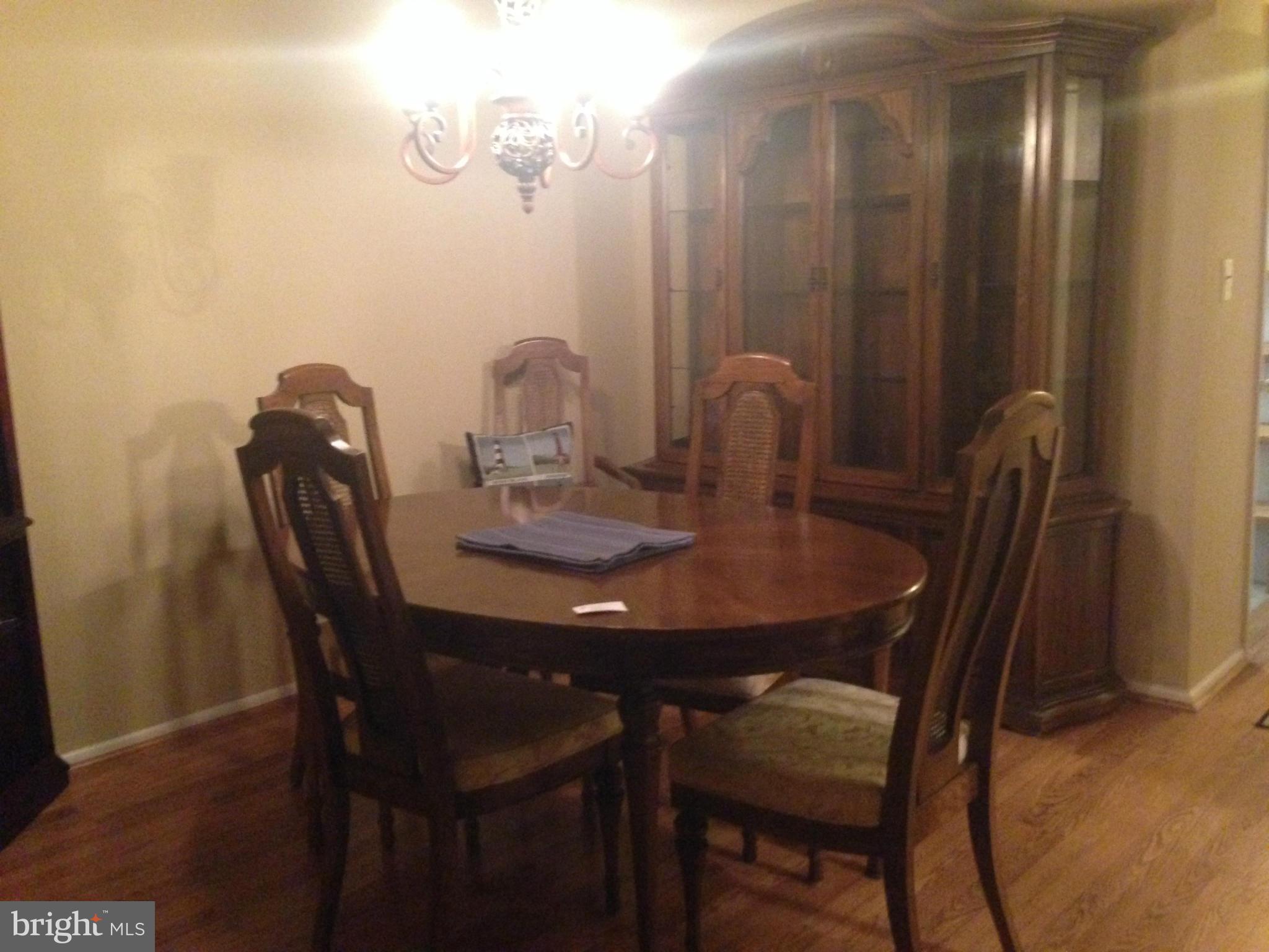 11368 Cherry Hill Road, Unit 304 Beltsville, MD 20705 - Photo 10 of 11 a view of a dining room with furniture and wooden floor