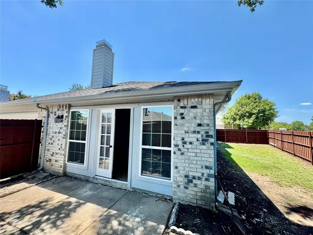 a view of a hallway with wooden floor and windows