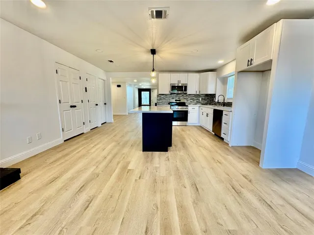 a large kitchen with cabinets