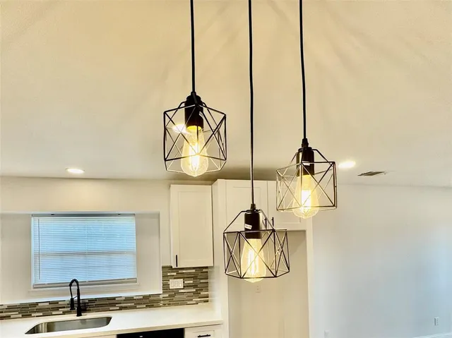 a large kitchen with stainless steel appliances granite countertop a stove and a refrigerator