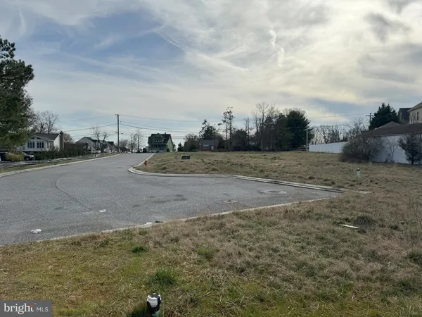 a view of a yard with wooden fence