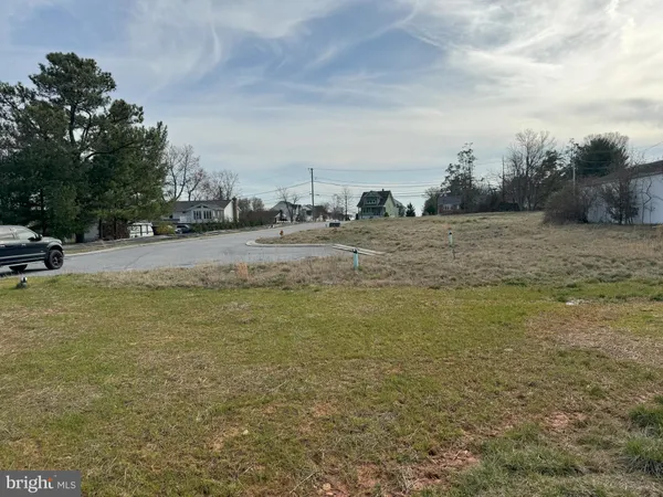 a view of a field with trees in the background