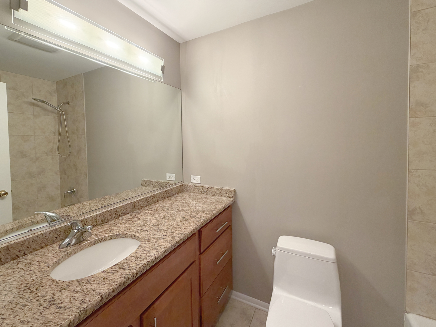 22 Creekside Circle, Unit D Elgin, IL 60123 - Photo 16 of 23 a bathroom with a granite countertop sink and a mirror