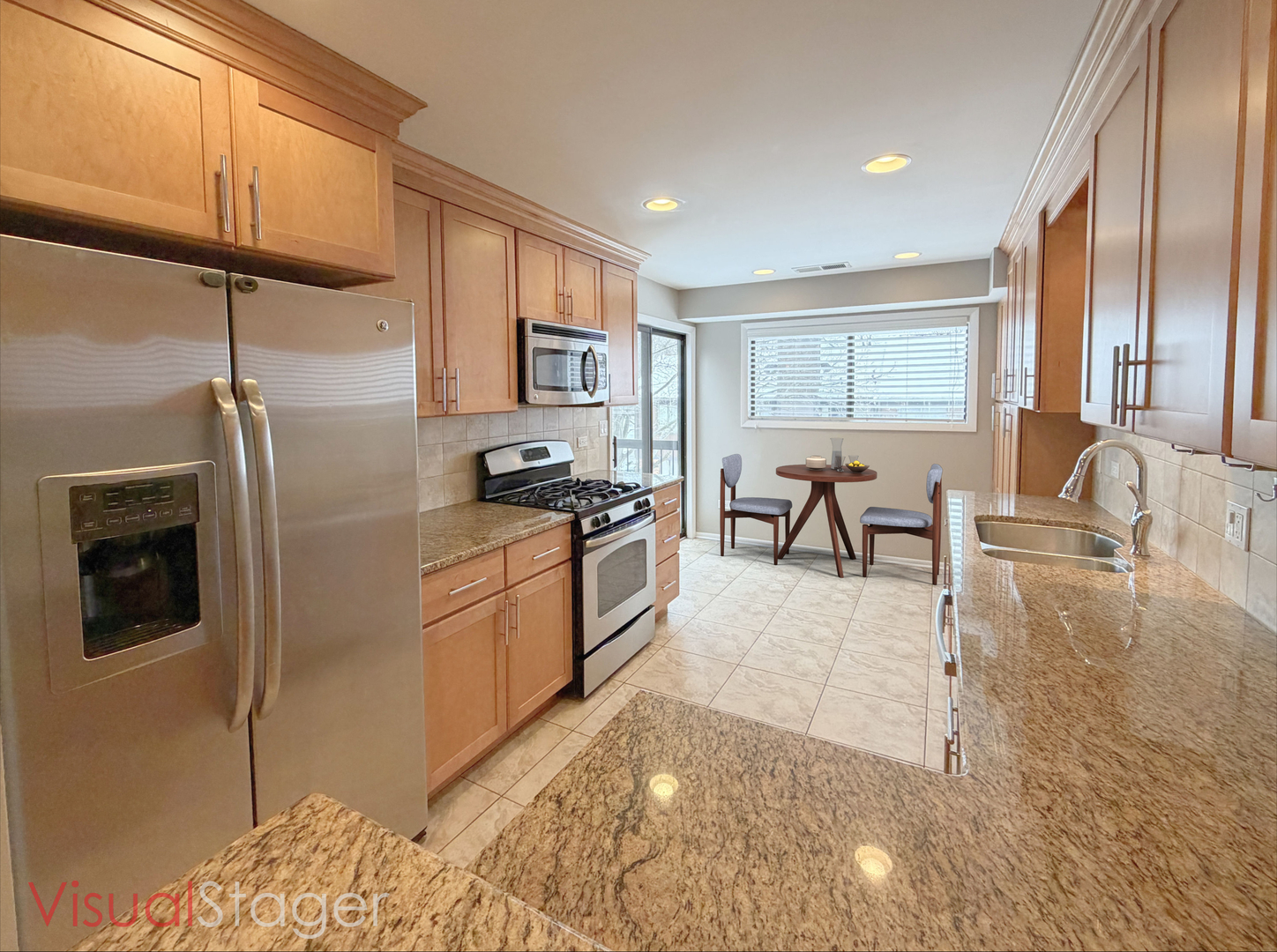 22 Creekside Circle, Unit D Elgin, IL 60123 - Photo 10 of 23 a kitchen with stainless steel appliances granite countertop a stove a sink and a refrigerator