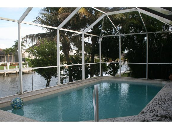 331 Waterleaf Court Marco Island, FL 34145 - Photo 4 of 5 a view of a house with a floor to ceiling window and wooden fence