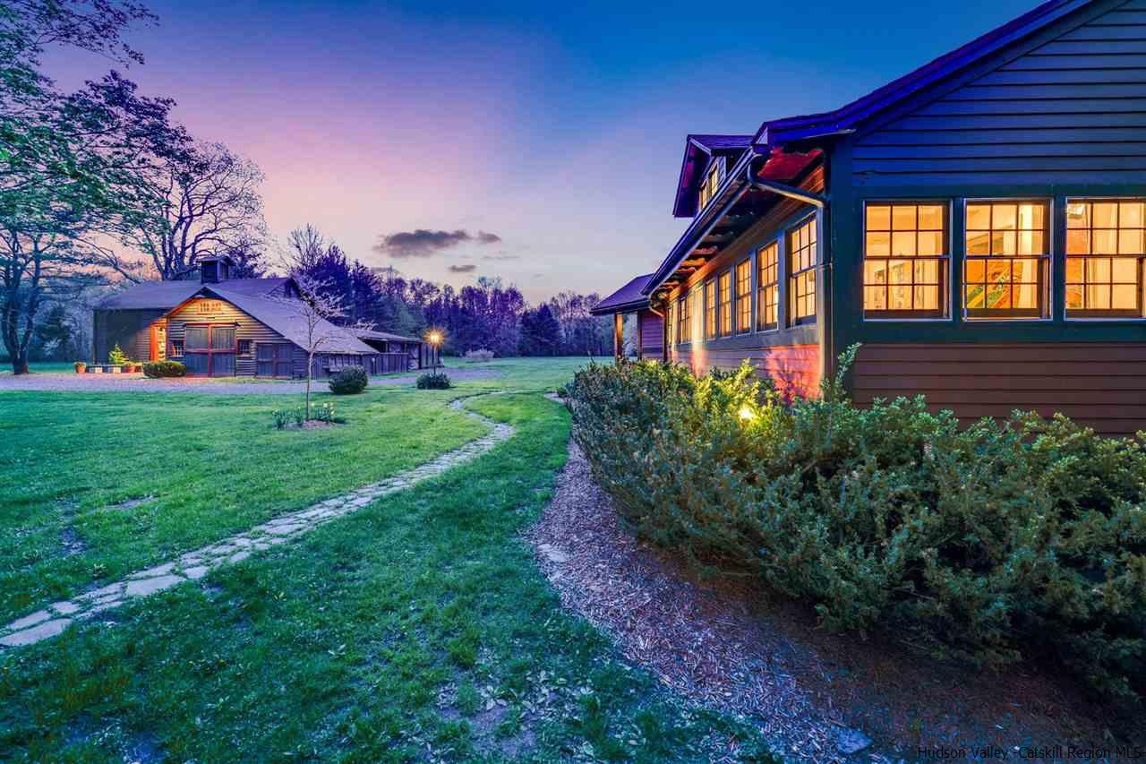a front view of house with yard and green space