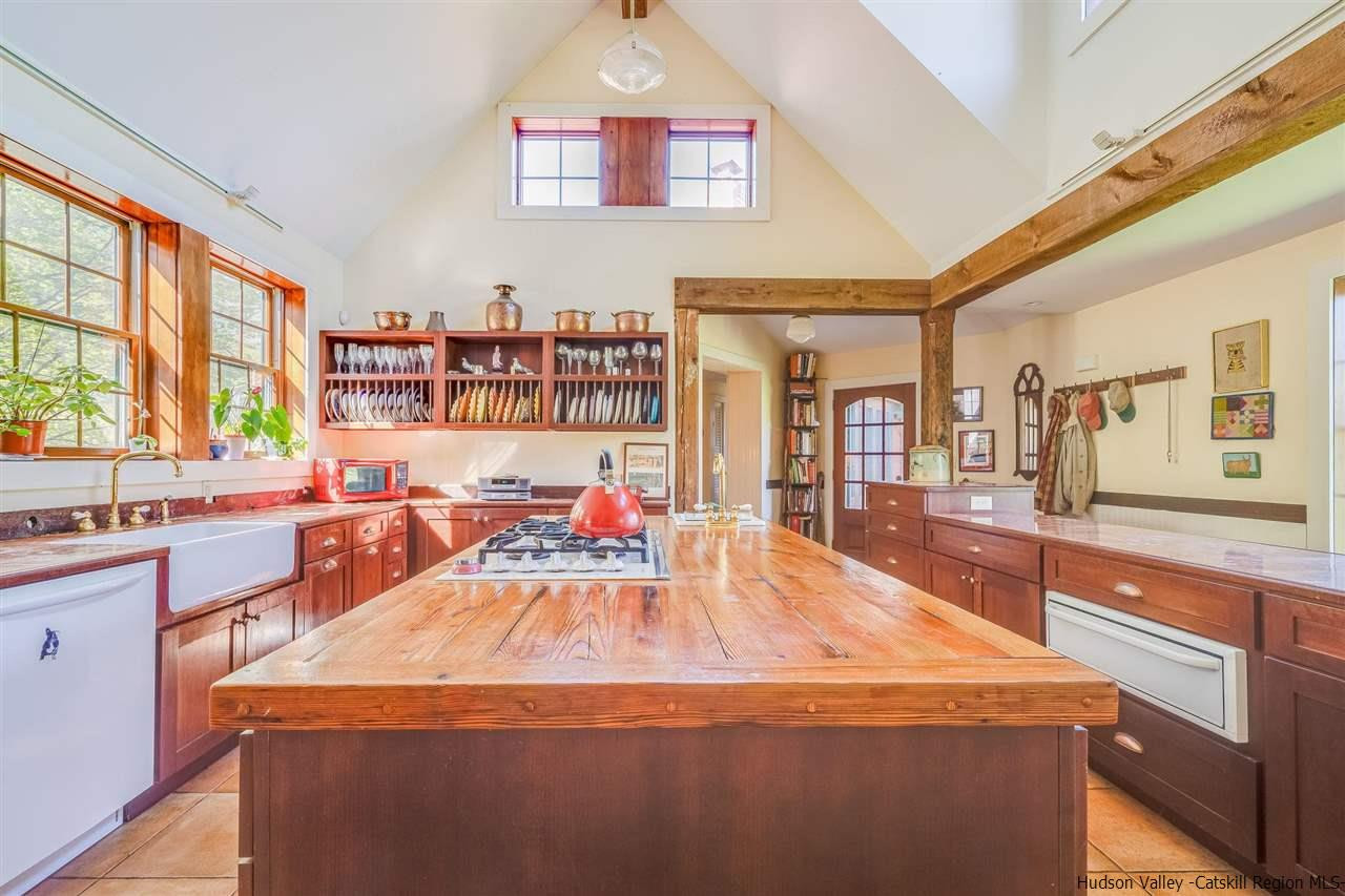 1245 High Falls Road Catskill, NY 12414 - Photo 11 of 34 a room with stainless steel appliances kitchen island granite countertop a sink and wooden cabinets