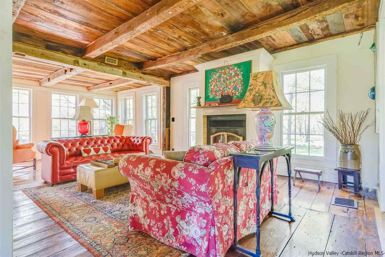 1245 High Falls Road Catskill, NY 12414 - Photo 16 of 34 a living room with furniture a fireplace and a table