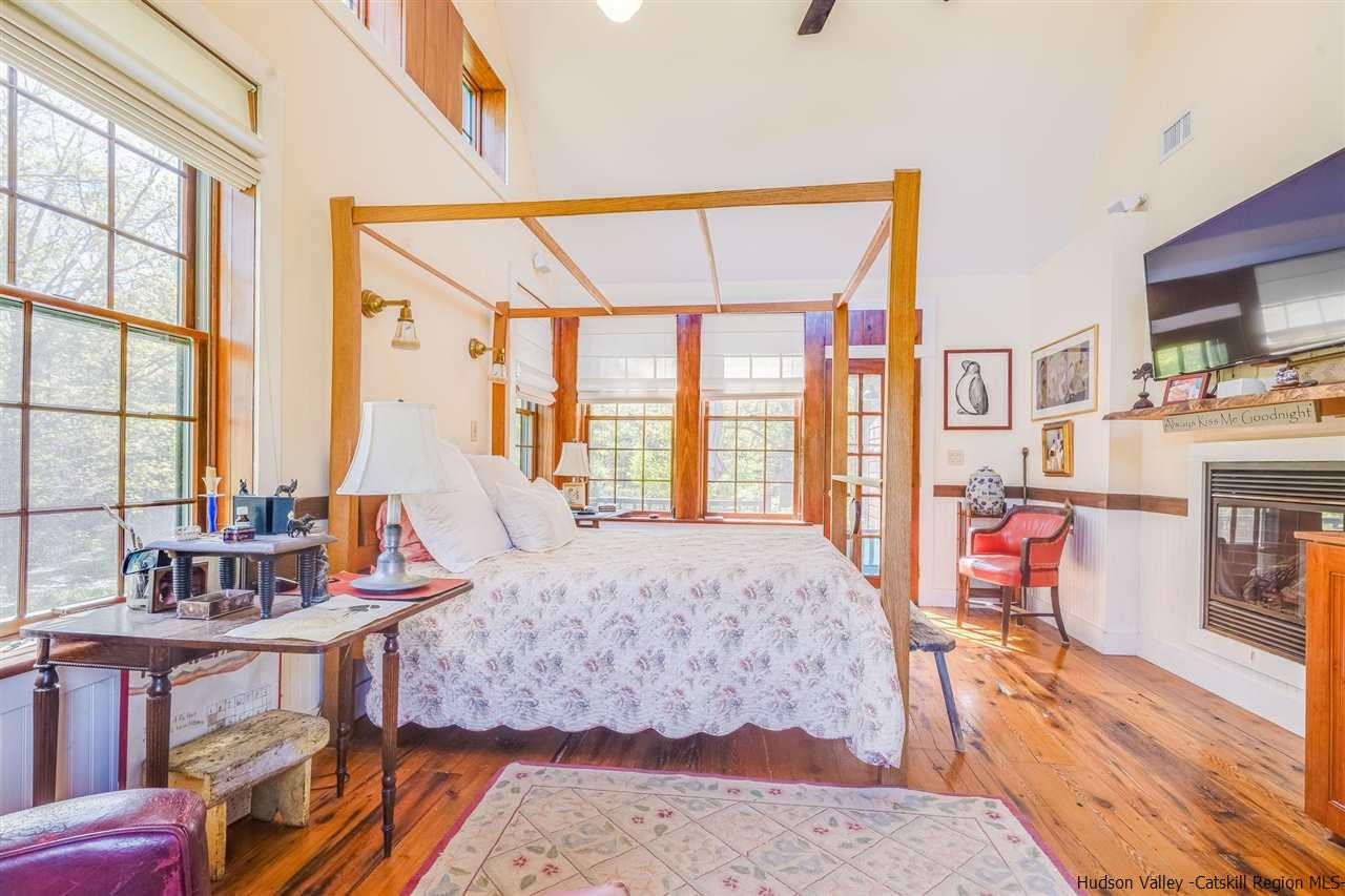 1245 High Falls Road Catskill, NY 12414 - Photo 21 of 34 a bedroom with a bed and large windows