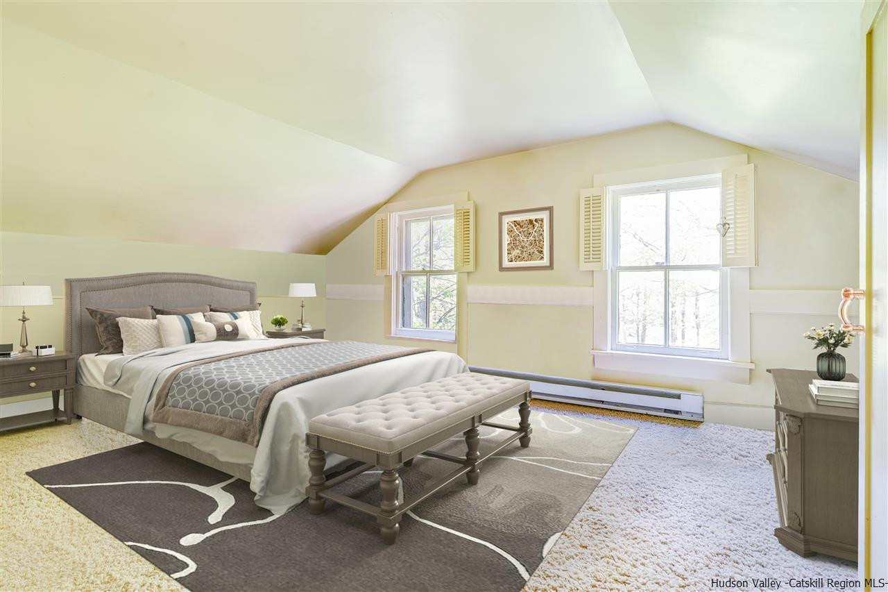 1245 High Falls Road Catskill, NY 12414 - Photo 25 of 34 a spacious bedroom with a bed a table and windows