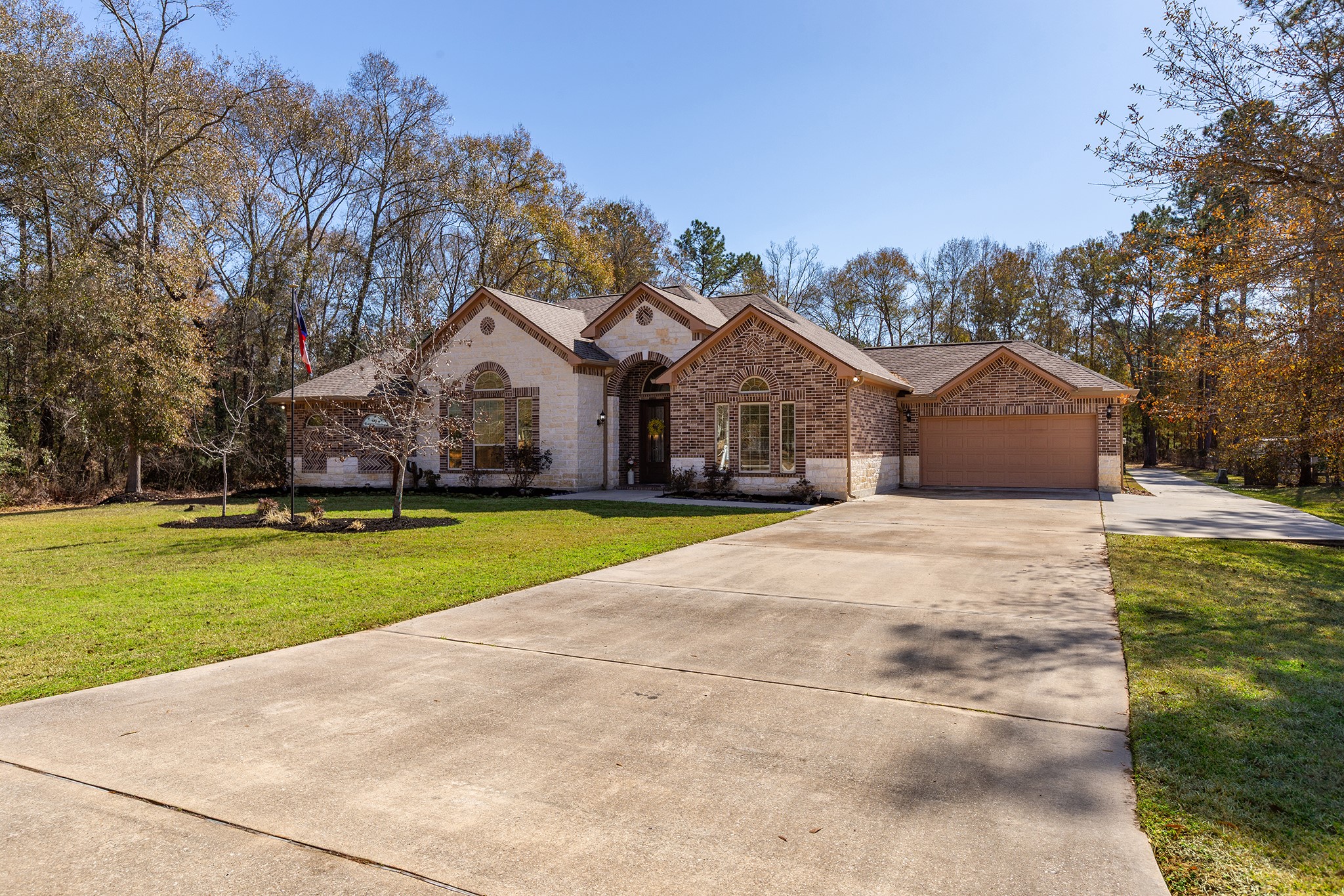 27688 Rio Blanco Drive Splendora, TX 77372 - Photo 41 of 50 a view of large house with a big yard and large trees
