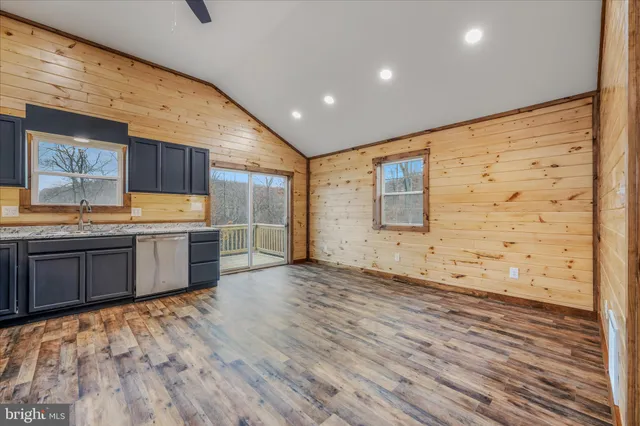 a view of a kitchen with wooden floor and a sink