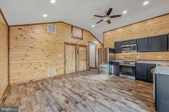 a view of kitchen with cabinets and wooden floor