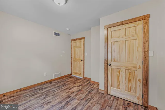 a view of a room with wooden floor