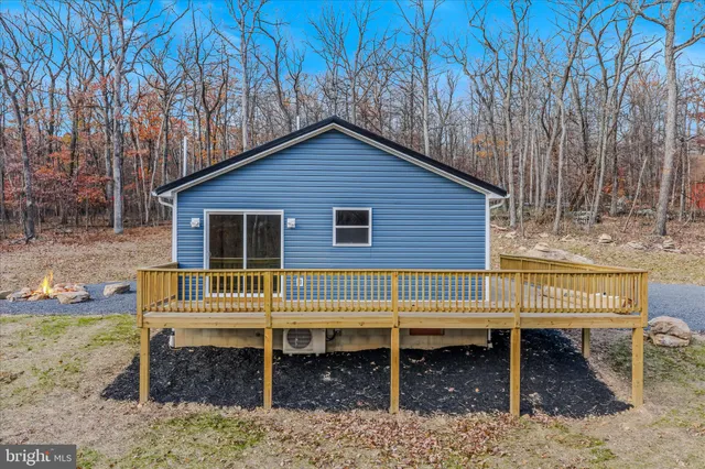 a small wooden bench sitting in front of a house