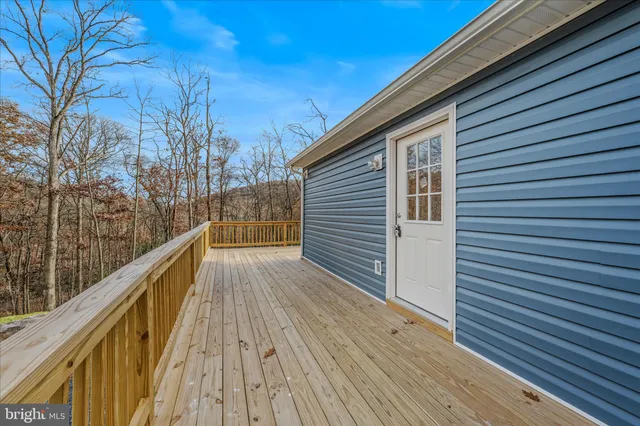 a view of a house with backyard and trees