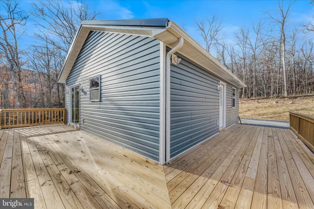 a view of backyard with a deck