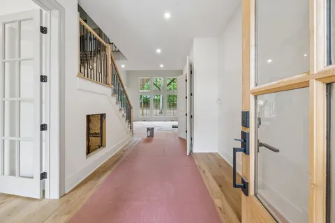 a view of a hallway with furniture and a fireplace